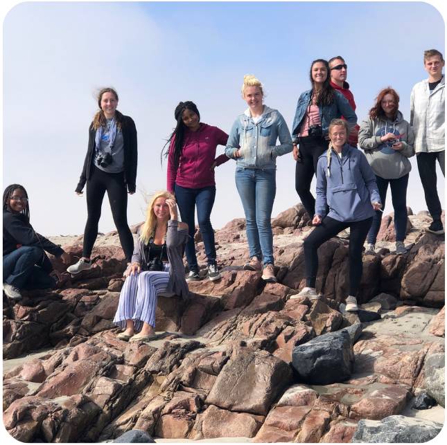 Large group of students posed on rocks during study abroad trip to Namibia